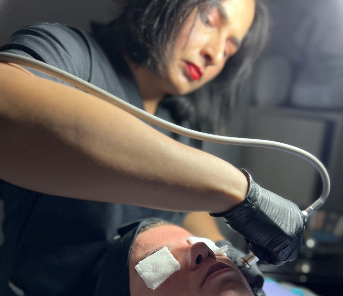 Reshma, aesthetician, performing a microdermabrasion treatment on a client